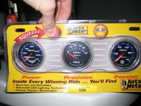 1998 Lincoln Town Car - A set of Auto Meter Cobalt series gauges, including water temperature, voltage, and oil pressure, are displayed in their retail packaging.
