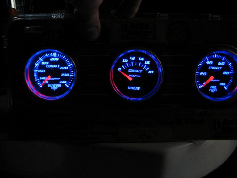Three blue-lit Auto Meter Cobalt gauges: water temp, volts and oil pressure