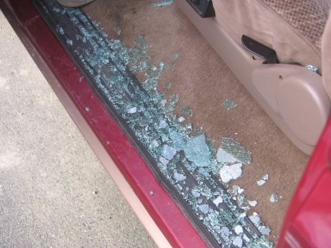 1995 Ford Bronco - Broken window glass scattered across the car's interior floor.