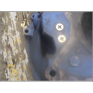1972 Ford Ranchero - This image shows a close-up view of an automotive part, possibly related to a transmission rebuild, with two screws securing a plate.