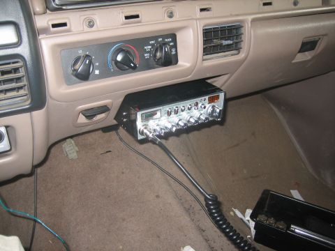 1995 Ford Bronco - Tan interior view of a CB radio with red LED channel display and chrome-knob face mounted under the dash, below the rotary heater/AC contro…