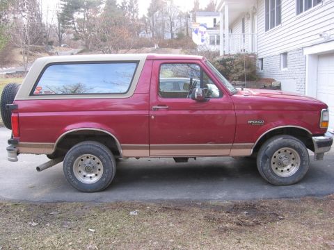 1995 Ford Bronco - This 1995 Ford Bronco is parked in front of a house with a garage.