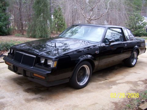 1979 Ford F-150 - This black 1987 Buick Grand National is captured in a 3/4 front view, parked outdoors on a concrete driveway.