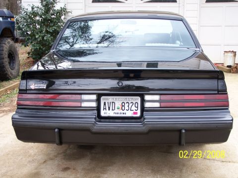 1979 Ford F-150 - Black 1987 Buick Regal Grand National rear view, showing taillights and license plate.