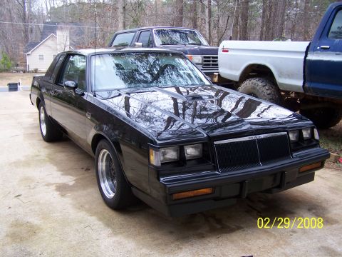 1979 Ford F-150 - Black 1987 Buick Regal Grand National parked in a driveway with other vehicles.