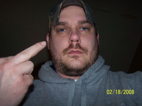 1979 Ford F-150 - A man wearing a camouflage hat and a gray hoodie points with his middle finger towards the camera. A date stamp reads 02/18/2008.