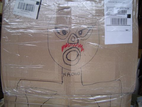 1989 Ford Bronco - A drawing of a face with a mustache is on a cardboard box wrapped in plastic.