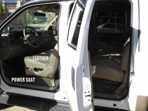 2000 Ford F-250 - Interior view of a 2000 Ford F-250, highlighting the leather power seats and rear seating area.
