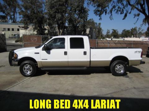 2000 Ford F-250 - This 2000 Ford F-250 Super Duty pickup truck is shown from its side profile, highlighting its long bed and crew cab configuration.