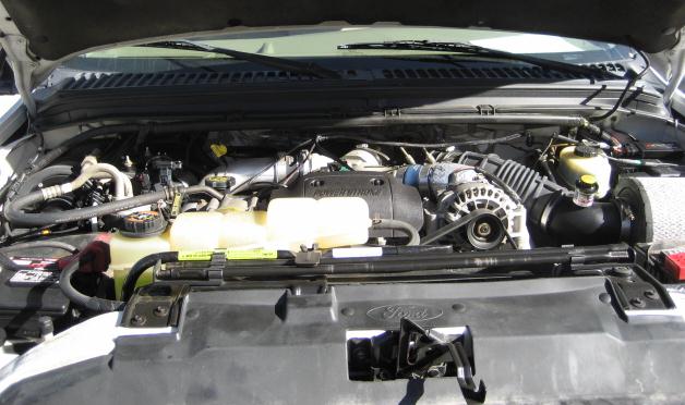 2000 Ford F-250 engine bay with Power Stroke diesel engine visible. Supermotors.net logo in lower right