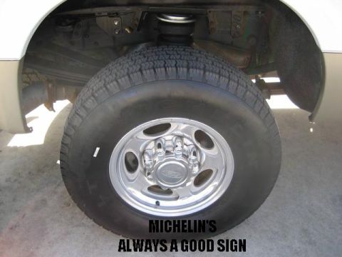 2000 Ford F-250 - The rear wheel and suspension of a truck are shown, with visible text overlaying the image.