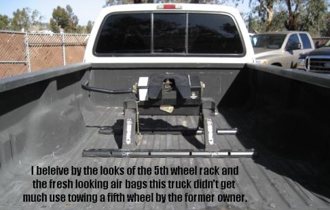 2000 Ford F-250 - The truck bed shows a fifth wheel hitch, suggesting it was used for towing, but the specific model year is not visually identifiable.