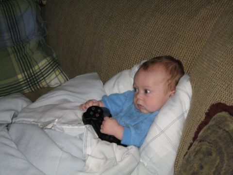 1988 Ford Bronco - Baby holding a video game controller on a couch.