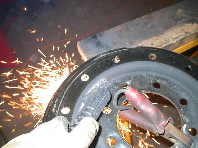 The ridge on the outer rim acts as a guide for the plasma cutter.  I found it was easiest to make a smooth cut by rotating the rim under the torch.