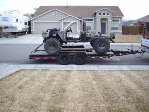 1982 Toyota 4Runner - A heavily modified vehicle chassis, stripped down and loaded onto a trailer for transport.