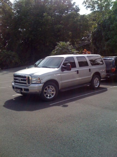 2005 Ford Excursion - A silver Ford Excursion is parked in an outdoor lot, showing its front and side profile.