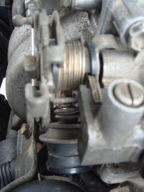 1991 Toyota Tacoma - Close-up view of a vehicle's throttle body and linkage mechanism.