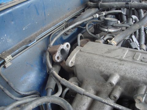1991 Toyota Tacoma - Close-up view of engine components, including the intake manifold and exhaust flange.
