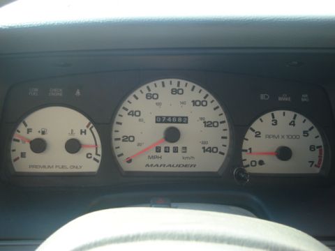 2000 Ford Crown Victoria - The dashboard displays gauges for speed, RPM, fuel, and temperature, with 'Marauder' visible on the speedometer.