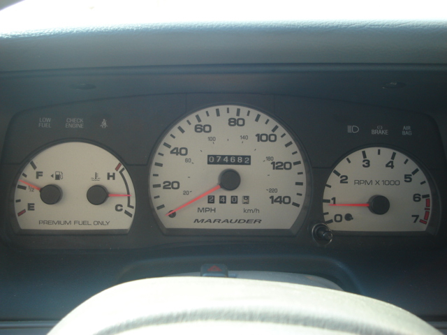 Car dashboard with speedometer, tachometer, fuel gauge, and temperature gauge. Odometer reads 074682. The speedometer indicates 'Marauder'