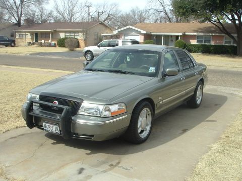 2003 Mercury Grand Marquis - This 2003 Mercury Grand Marquis, equipped with a front push bar, is seen parked in a suburban driveway.