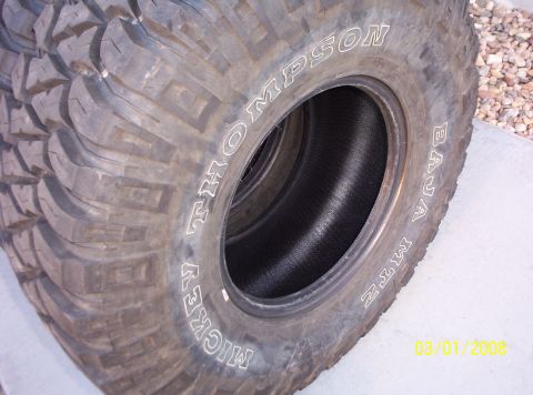 1995 Ford Bronco - Close-up view of several Mickey Thompson Baja MTZ tires stacked together.