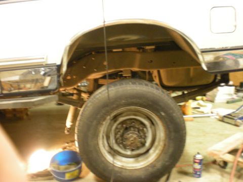 1993 Ford Bronco - Close-up view of the rear wheel well and suspension of a 1993 Ford Bronco.