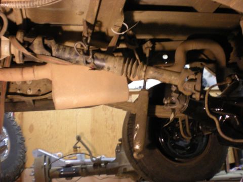 1993 Ford Bronco - Underside view of a vehicle's drivetrain and suspension system with various mechanical parts visible.