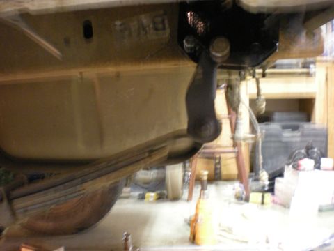 1993 Ford Bronco - Close-up view of a vehicle's undercarriage, focusing on the suspension system and leaf springs.