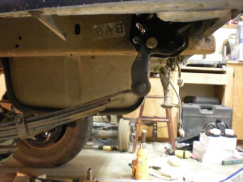 1993 Ford Bronco - Close-up view of the underside of a vehicle, focusing on the leaf spring and suspension system.