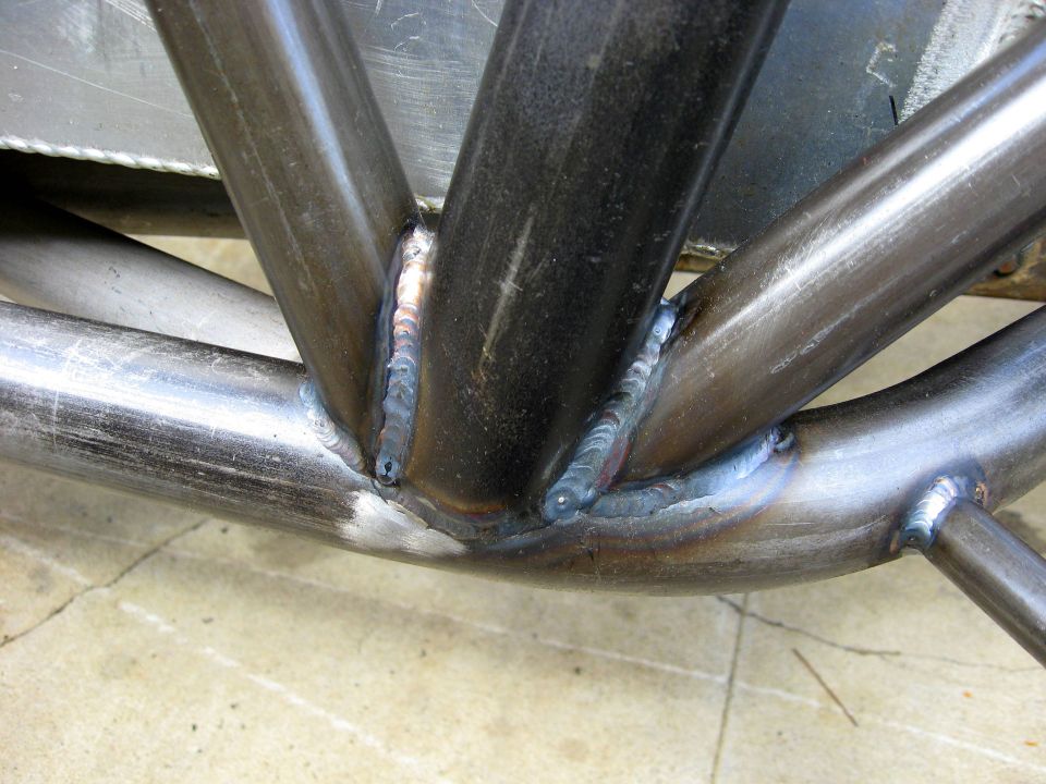 Close-up of welded metal tubes, likely part of a roll cage or custom frame