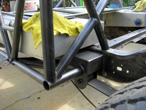 1995 Ford Bronco - Close-up view of a custom roll cage and chassis construction, with a yellow towel on a fuel tank.