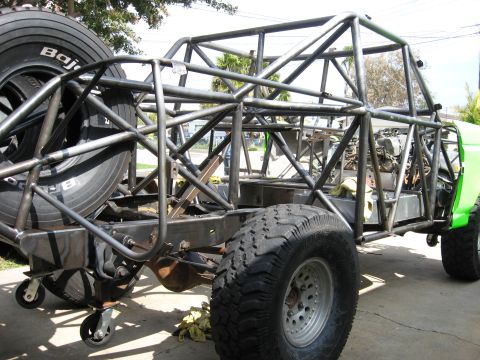 1995 Ford Bronco - Custom off-road truck chassis under construction with extensive roll cage tubing.
