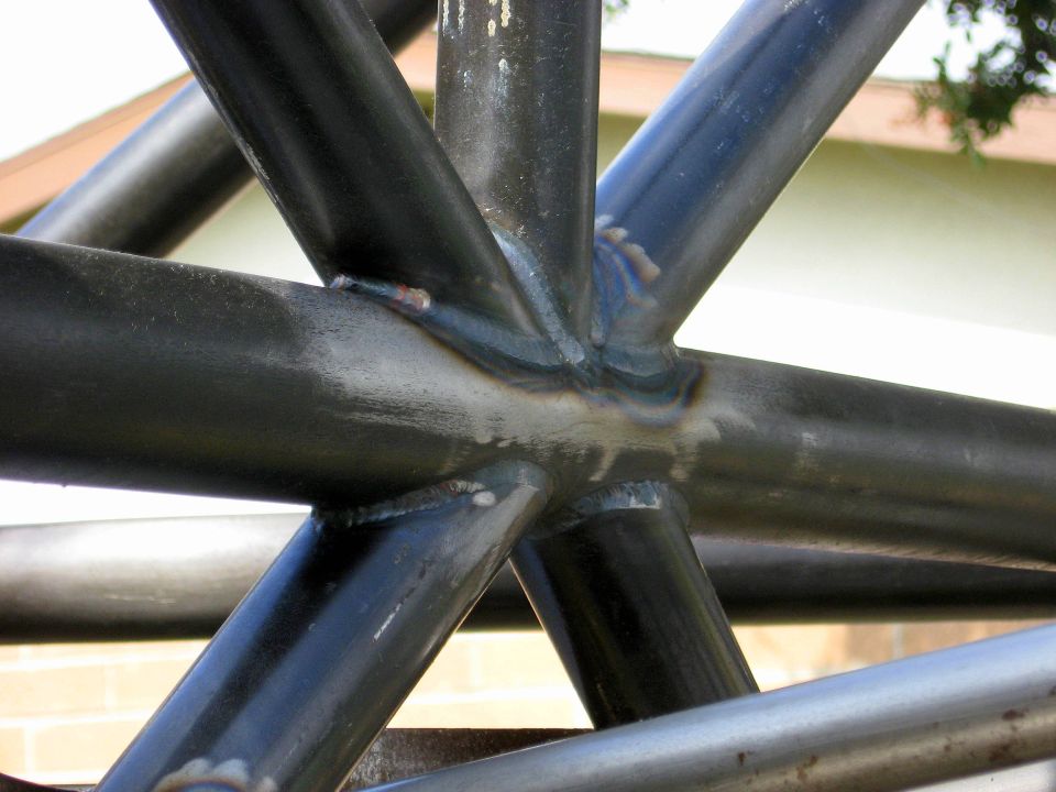 Roll cage with visible welds and "SUPERMOTORS.NET" watermark