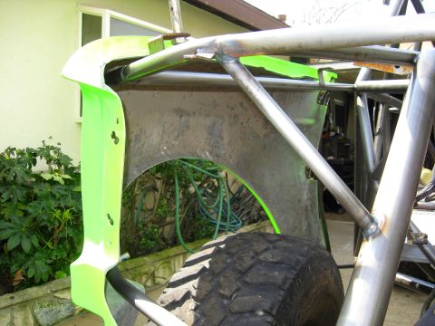 1995 Ford Bronco - Close-up of a custom off-road buggy's roll cage and a neon green fender panel.