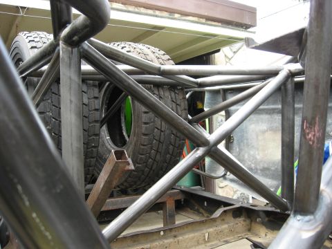 1995 Ford Bronco - Interior view of a vehicle's roll cage and spare tires, suggesting off-road or racing modifications.