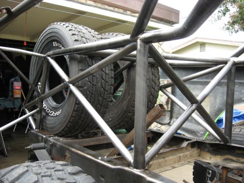 1995 Ford Bronco - Spare tires are mounted within the custom roll cage of a race truck build.