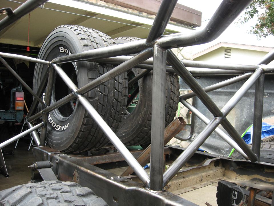 Roll cage structure with two BFGoodrich spare tires mounted inside. Part of an off-road race truck build