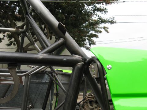 1995 Ford Bronco - Detail of a custom-built off-road vehicle's tubular frame and bright green bodywork.