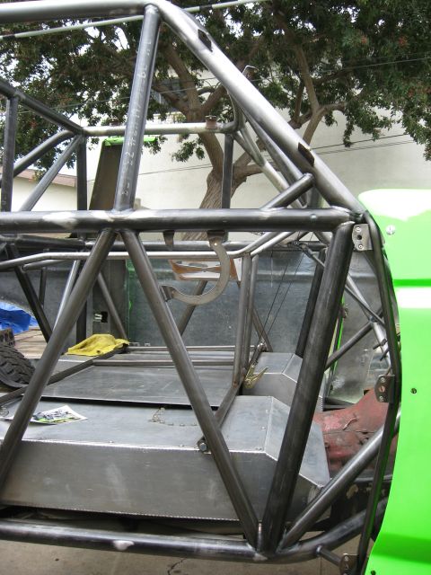 1995 Ford Bronco - The interior of a custom-built off-road vehicle shows a complex metal roll cage and fuel tanks.