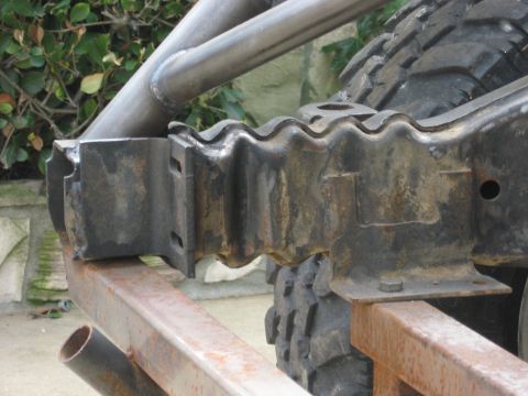 1995 Ford Bronco - Detail of an off-road vehicle's suspension system, showing robust metalwork and a tire.