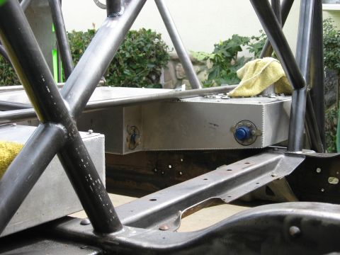 1995 Ford Bronco - Close-up view of a custom fuel tank and roll cage assembly, with a yellow towel draped over the tank.