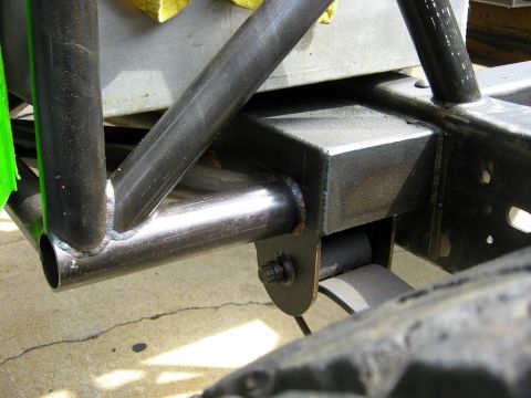 1995 Ford Bronco - Close-up view of custom roll cage and suspension components on a vehicle frame.