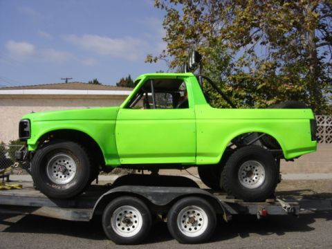 1995 Ford Bronco - Modified 1995 Ford Bronco on a trailer, painted bright green with roll cage.