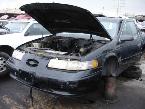 1993 Ford Taurus - 1993 Ford Taurus SHO with its hood open, showing the engine bay.