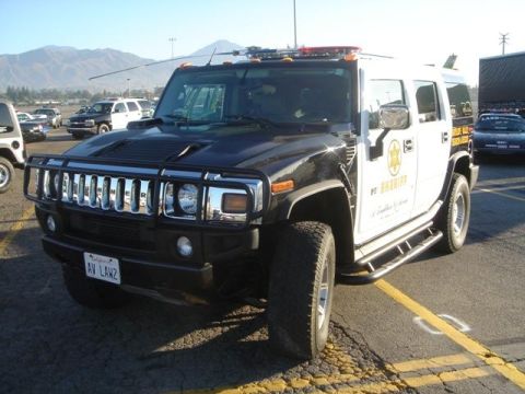 1991 Ford Crown Victoria - This Hummer H2 is marked as a sheriff vehicle, with "H SHERIFF" visible on the door.