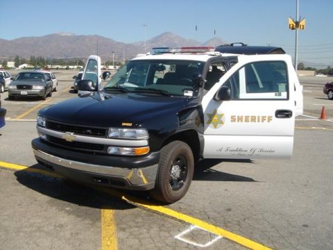 1991 Ford Crown Victoria - A Sheriff's SUV is parked with its doors open, displaying the "Sheriff" text and a badge.