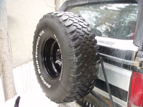 1992 Ford Bronco - one of my old crappy 35" BFG M/T's as my spare. so far,... the spare tire rack has held up to the weight.