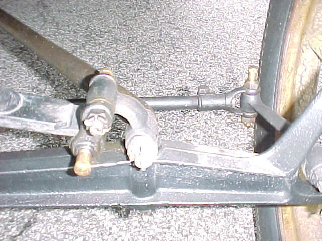Steering tie rod has fine thread adjustment on drivers side with clamp bolt vertical to the ground.