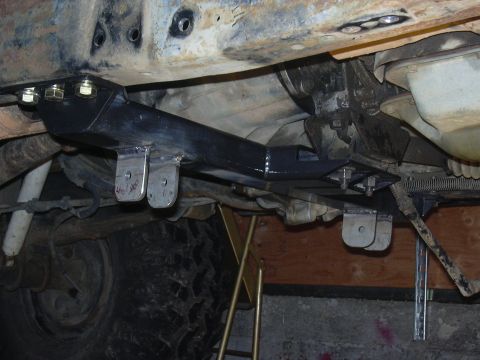 1991 Ford Bronco - Aftermarket crossmember installation visible on underside of vehicle.